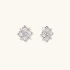 Ornate sterling silver stud earrings with mandala-inspired filigree pattern and four freshwater pearls on beige background