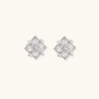 Ornate sterling silver stud earrings with mandala-inspired filigree pattern and four freshwater pearls on beige background