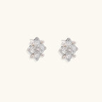 Ornate sterling silver stud earrings with mandala-inspired filigree pattern and four freshwater pearls on beige background