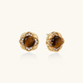 Gold-plated stud earrings with ornate floral frames surrounding cabochon tiger's eye stones and zirconia accents