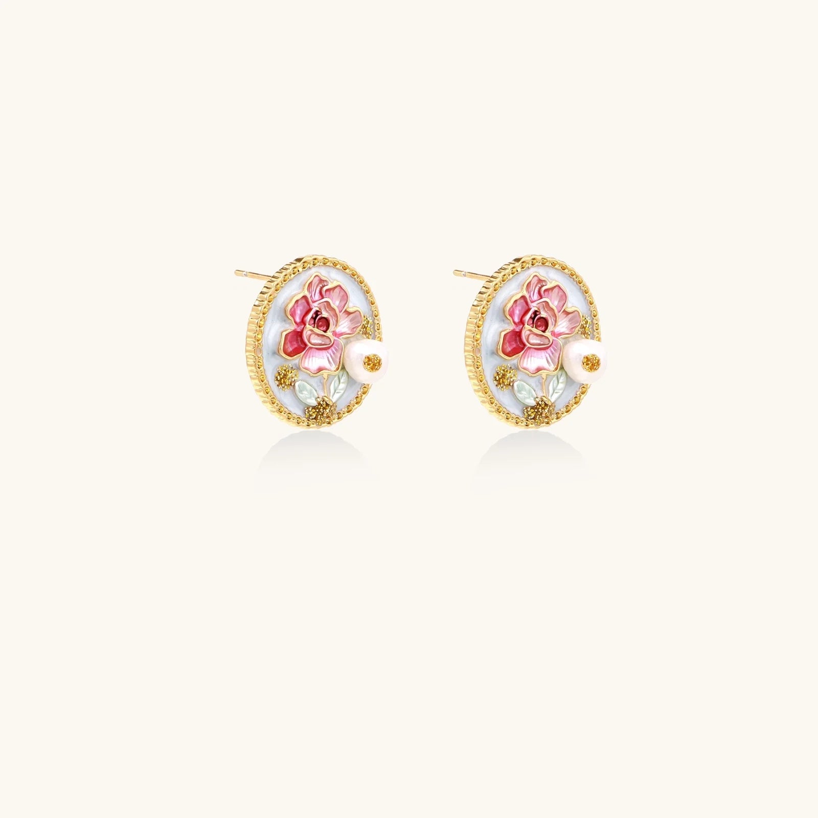 Gold-rimmed circular stud earrings with hand-painted pink peony enamel and pearl accents on white background