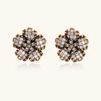 Gold-plated floral stud earrings with geometric zirconia crystals arranged in five-petal design on cream background