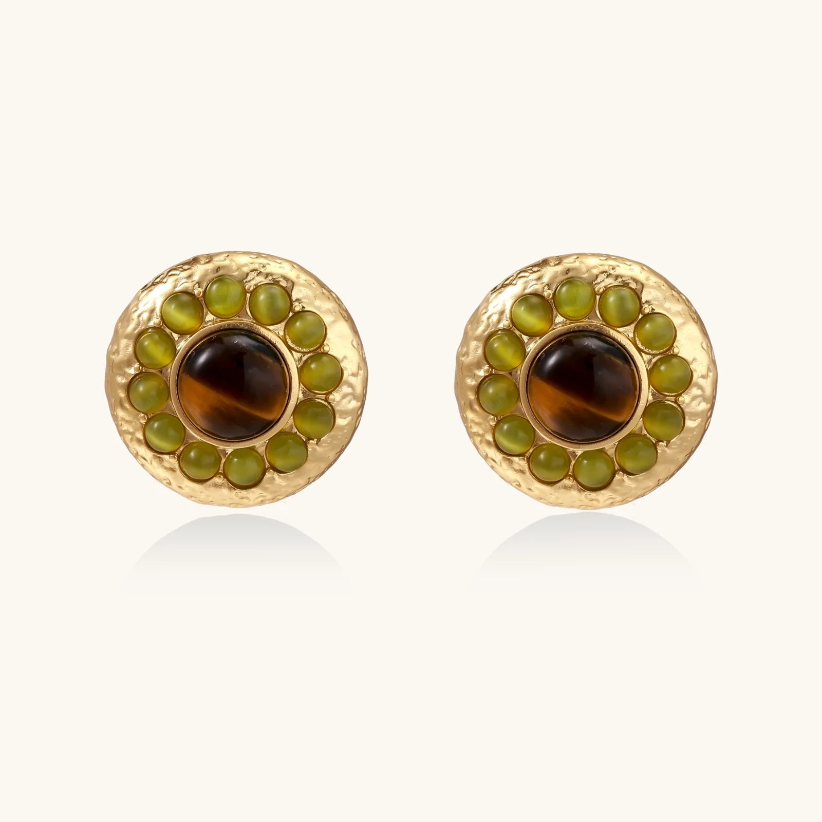 Round hammered gold studs with brown tiger's eye center surrounded by olive green liuli stones on white background.