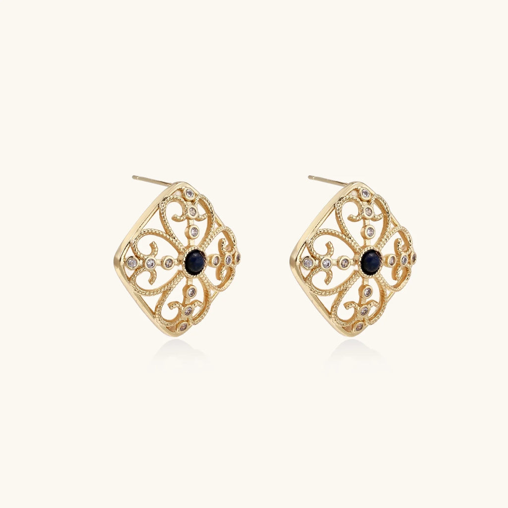 Gold filigree stud earrings with navy lapis lazuli center stone and mother-of-pearl accents in ornate quatrefoil design