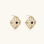 Gold filigree stud earrings with navy lapis lazuli center stone and mother-of-pearl accents in ornate quatrefoil design