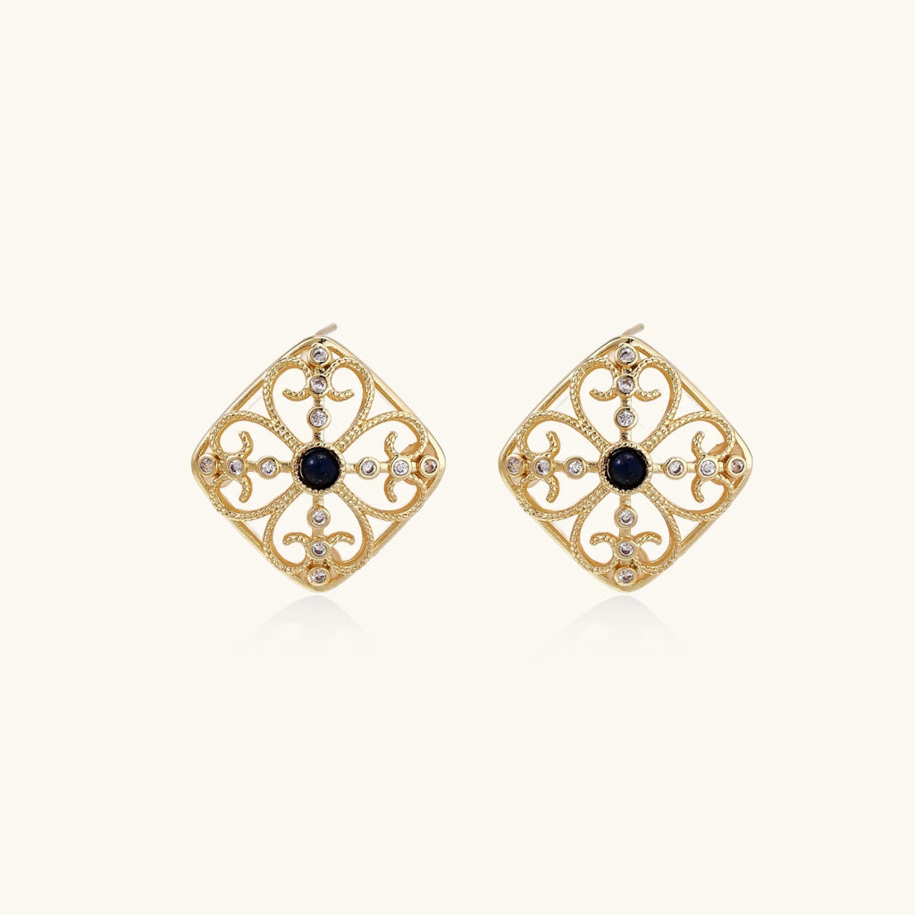 Gold filigree stud earrings with navy lapis lazuli center stone and mother-of-pearl accents in ornate quatrefoil design