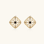 Gold filigree stud earrings with navy lapis lazuli center stone and mother-of-pearl accents in ornate quatrefoil design