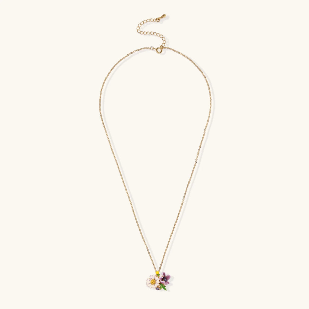 Gold-plated necklace with pink and purple enamel flower pendant featuring crystal accents on cream background