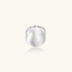 Minimalist brushed sterling silver dome ring with adjustable band on white background, front view.