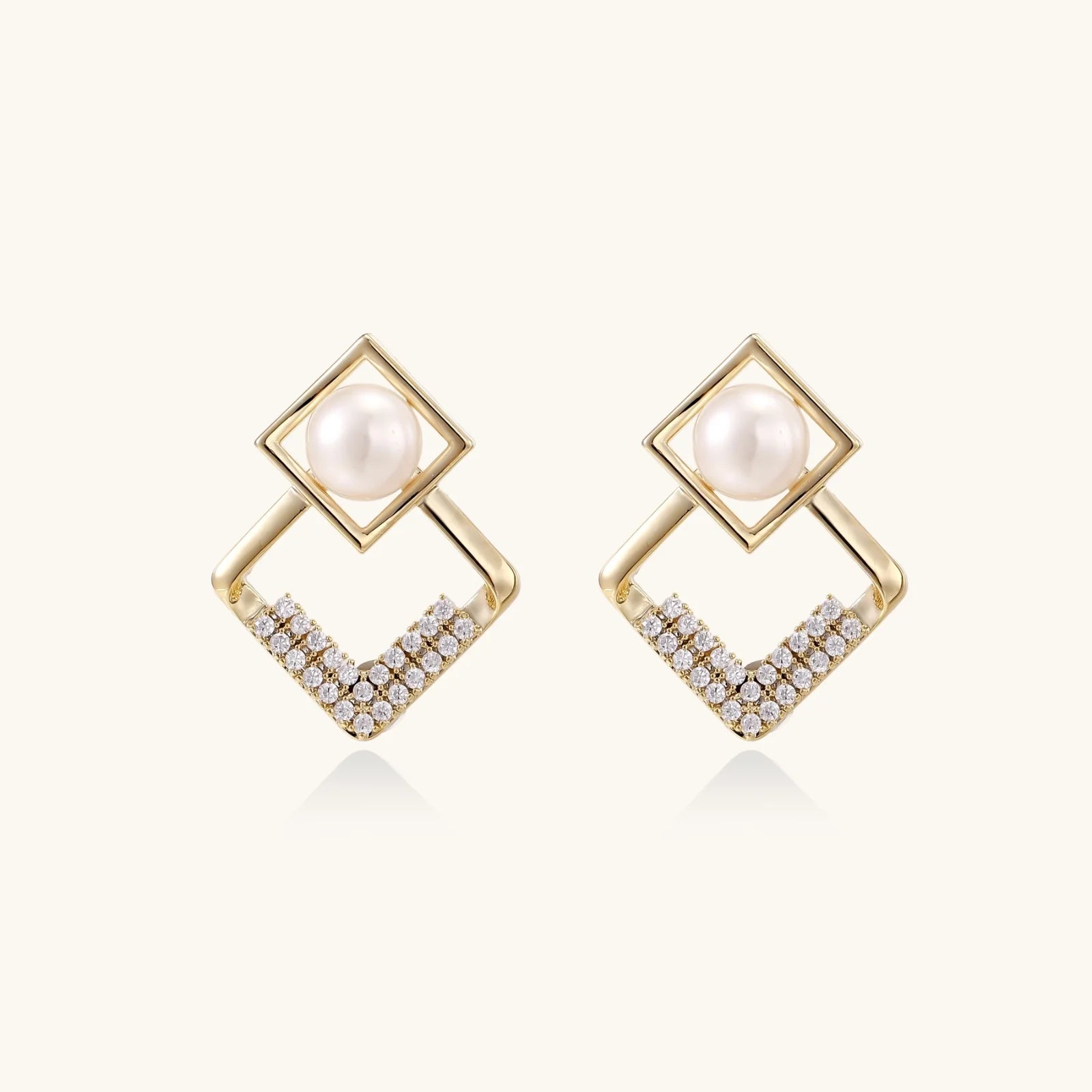 Gold-plated double square frame earrings with freshwater pearl and crystal accents on white background
