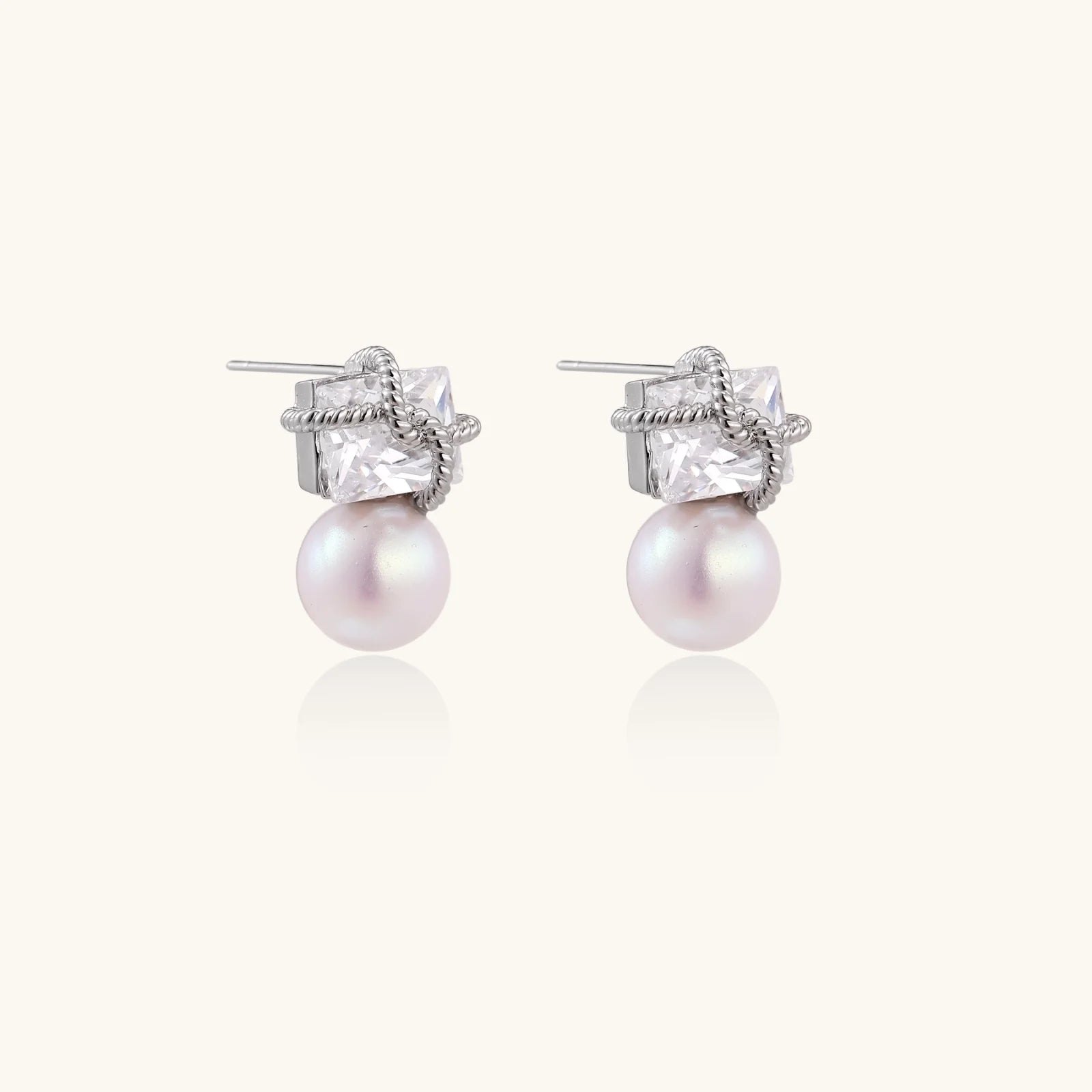 White gold stud earrings with square crystal stones in twisted frames and pink freshwater pearl drops below