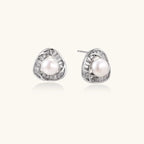Triangular white gold plated stud earrings with central freshwater pearl and baguette-cut stones on white background