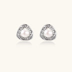 Triangular white gold plated stud earrings with central freshwater pearl and baguette-cut stones on white background
