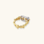 Triple-band gold ring with spherical bead chains and two crystal-pavé bars on cream background