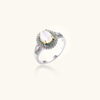 Vintage-style cocktail ring with luminous cat's eye center stone surrounded by turquoise and crystal double halo on white gold plated band