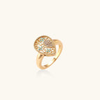 Teardrop-shaped gold-plated ring with turquoise enamel flowers and crystal pavé detail on cream background