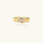 Gold-plated adjustable ring with ribbed band and rectangular pavé cubic zirconia panel on white background.