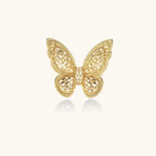 Intricate gold-plated butterfly ring with filigree cutout wings and adjustable band on white background.