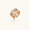 Two-tone gold and silver lattice ring with clover pattern and crystal accents on white background