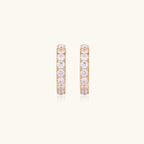 Gold pavé hoop earrings with two freshwater pearls nestled inside the curved design, featuring crystal-studded outer edge.