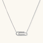 White gold plated necklace with dual-frame geometric pendant featuring crystal pavé border on pale background.