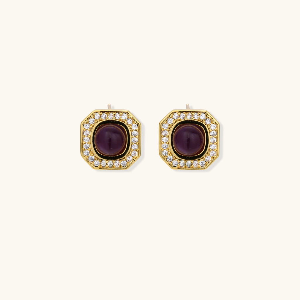 Gold-plated octagonal stud earrings with burgundy liuli centers and cubic zirconia halos on white background