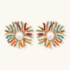 Vibrant starburst stud earrings with multicolor enamel rays and white pearl centers on gold-plated setting