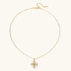 Gold-plated necklace with circular white enamel pendant featuring central zirconia stone and ornate decorative details