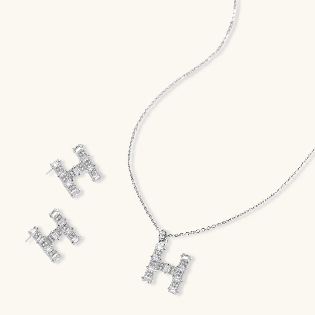 Letter H jewelry set featuring geometric crystal design in gold and white gold plated finish with adjustable chain necklace