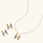 Letter H jewelry set featuring geometric crystal design in gold and white gold plated finish with adjustable chain necklace