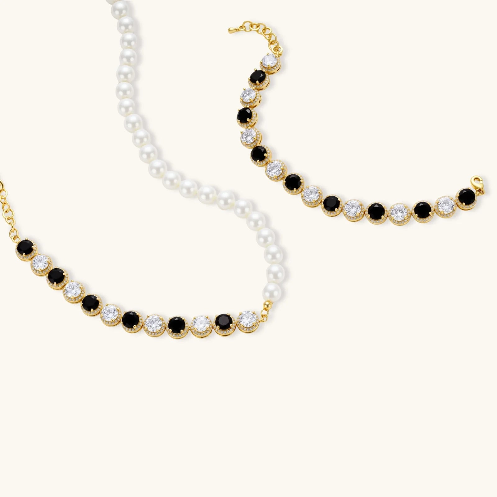 Gold-plated jewelry set with alternating black and clear cubic zirconia stones, featuring necklace, earrings and bracelet