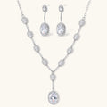 Elegant white gold plated jewelry set with oval cubic zirconia stones in halo settings, featuring Y-necklace and drop earrings.