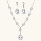 Elegant white gold plated jewelry set with oval cubic zirconia stones in halo settings, featuring Y-necklace and drop earrings.