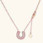 Sparkling horseshoe-shaped jewelry set with AAA cubic zirconia in gold-plated and white gold finishes on cream background.