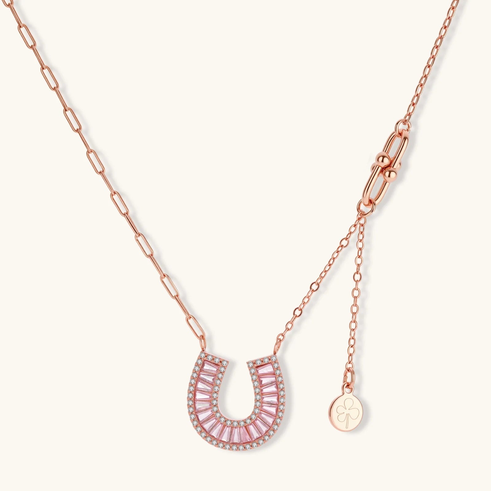 Sparkling horseshoe-shaped jewelry set with AAA cubic zirconia in gold-plated and white gold finishes on cream background.