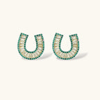 Sparkling horseshoe-shaped jewelry set with AAA cubic zirconia in gold-plated and white gold finishes on cream background.