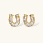 Sparkling horseshoe-shaped jewelry set with AAA cubic zirconia in gold-plated and white gold finishes on cream background.