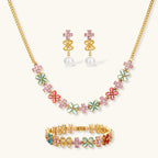 Gold-plated jewelry set with pink, turquoise and red flower-shaped cubic zirconia stones, featuring necklace, earrings and bracelet.
