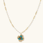 14K gold-plated floral jewelry set with blue cubic zirconia centers and pearl chain details on white background.