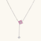 White gold plated jewelry set with pink cubic zirconia stones in geometric cross design, featuring Y-necklace and square stud earrings