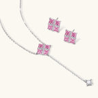 White gold plated jewelry set with pink cubic zirconia stones in geometric cross design, featuring Y-necklace and square stud earrings
