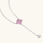 White gold plated jewelry set with pink cubic zirconia stones in geometric cross design, featuring Y-necklace and square stud earrings