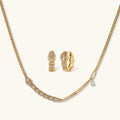Gold-plated necklace with geometric diamond segments and matching huggie earrings featuring cubic zirconia details