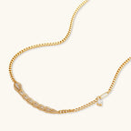 Gold-plated necklace with geometric diamond segments and matching huggie earrings featuring cubic zirconia details