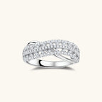 Sterling silver crossover ring with pavé-set moissanite stones creating an elegant infinity design on neutral background