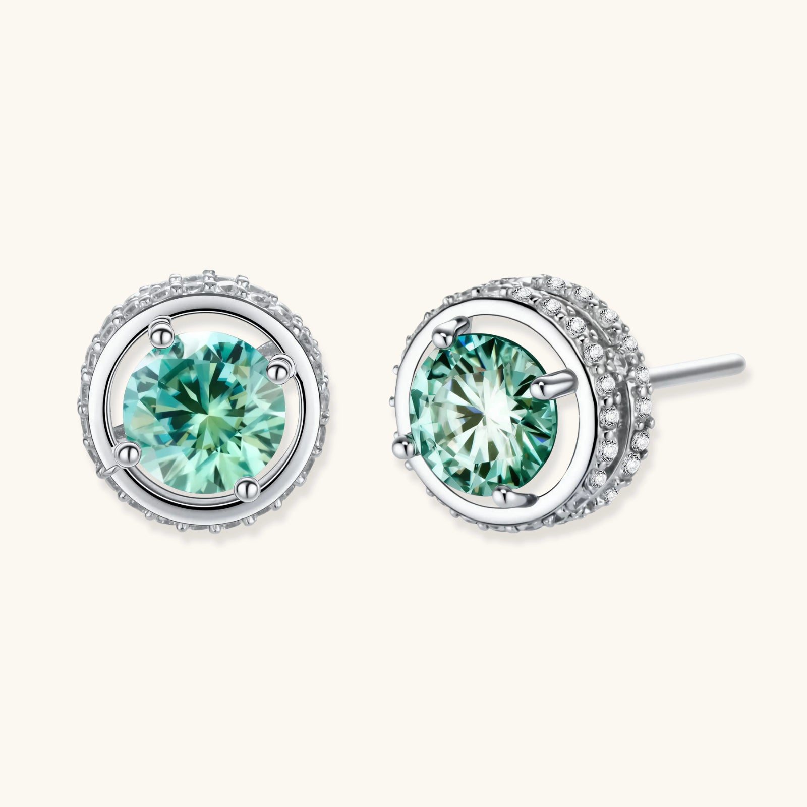 Round green moissanite stud earrings in sterling silver halo settings with brilliant sparkle on white background.