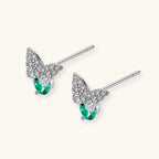 Sterling silver butterfly stud earrings with crystal wings and mint green center stones on cream background.
