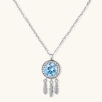 Sterling silver dreamcatcher pendant with blue moissanite center and three feather charms on adjustable chain.