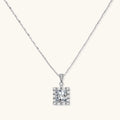 Square moissanite pendant with halo setting on delicate sterling silver chain against white background.