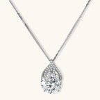 Sterling silver necklace featuring a large pear-shaped moissanite stone in an ornate setting with smaller accent stones